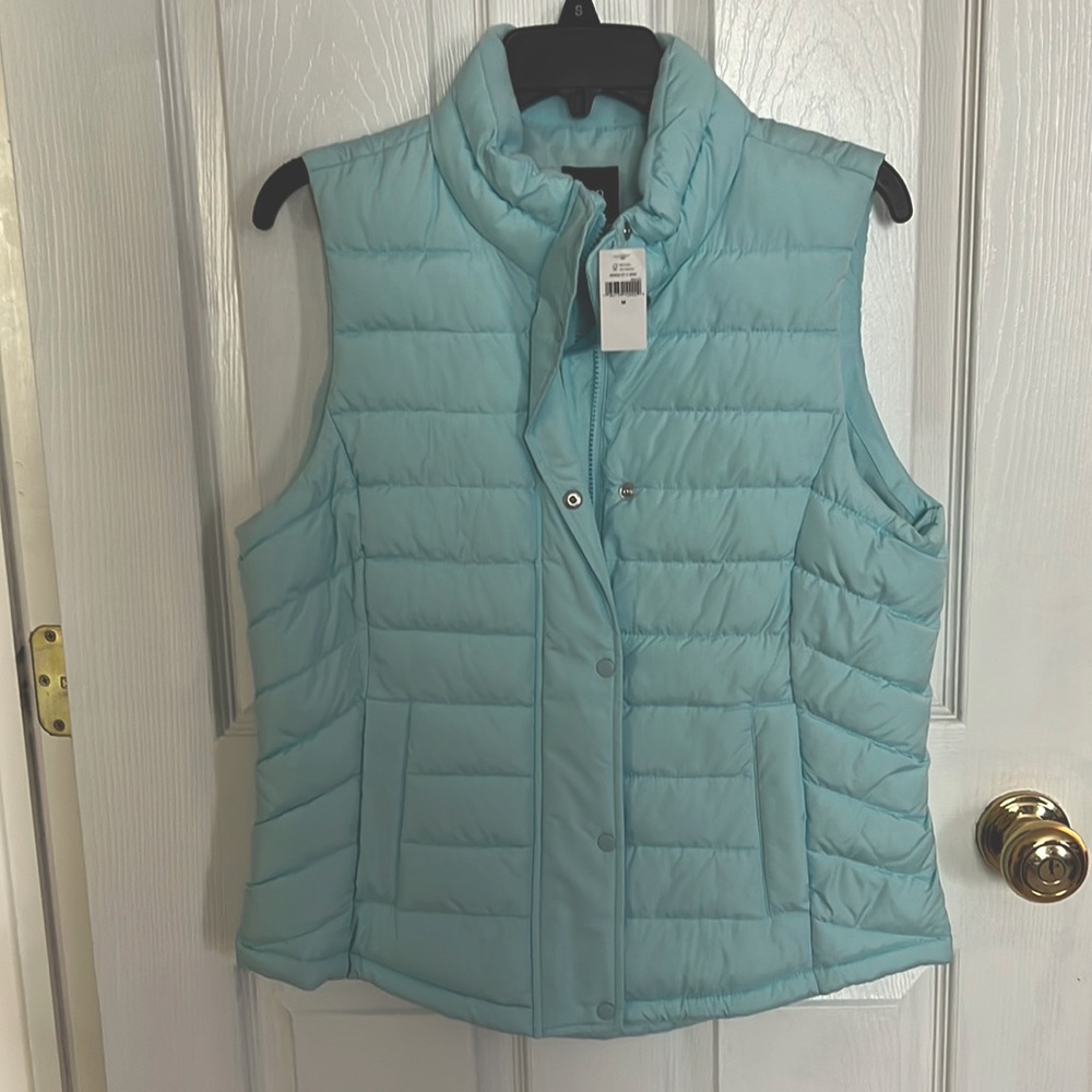 This is a brand new Gap puffer vest jacket in light teal color.